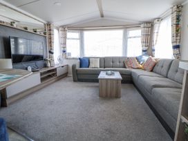 A living room with a sofa and coffee table at V9 Ty Mawr Holiday Park