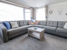 A living room with a sofa and coffee table at V9 Ty Mawr Holiday Park