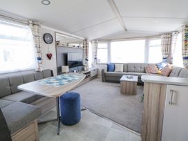 A living room with sofas and a coffee table at V9 Ty Mawr Holiday Park
