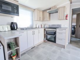 A kitchen with appliances and cabinets at V9 Ty Mawr Holiday Park 