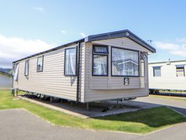 A caravan parked on a grassy area at V9 Ty Mawr Holiday Park
