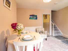 A dining room with a table and chairs at Bwthynbach in Porthmadog