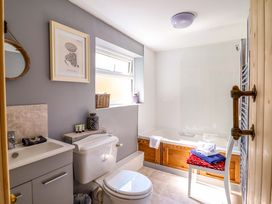 A bathroom with a bathtub and sink at Bwthynbach in Porthmadog