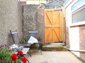 A garden seating area with chairs and a table at Bwthynbach in Porthmadog