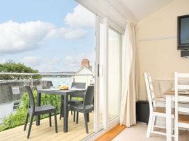 A dining area with outdoor table and chairs at 9 Slipway Cottages Rock