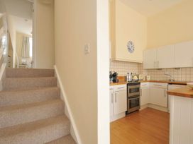 A kitchen with an oven and countertop at 9 Slipway Cottages in Rock
