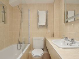 A bathroom with a toilet and sink at 9 Slipway Cottages Rock