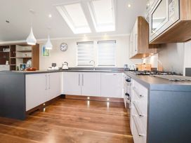 A kitchen with appliances and cabinetry at The Maples 44 St. Austell