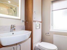 A bathroom featuring a sink, toilet, and shower at The Maples 44 St. Austell