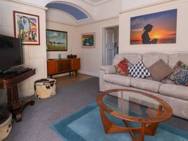 A living room with a television and sofa at Sandy Shore in Bridlington