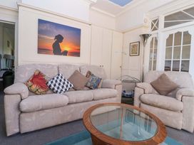 A living room with a sofa and armchair at Sandy Shore in Bridlington
