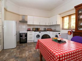 A kitchen with appliances and a dining table at Sandy Shore in Bridlington