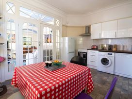 A kitchen with appliances and a dining table at Sandy Shore in Bridlington