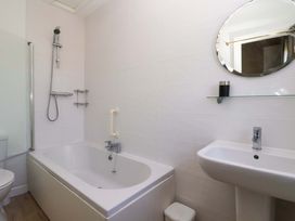 A bathroom with a bathtub and sink at Sandy Shore in Bridlington
