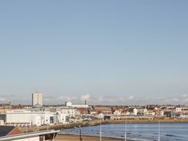 A seaside view with buildings and beach at Sandy Shore in Bridlington