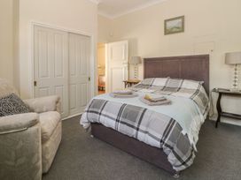 A bedroom with a bed and a sofa at Sandy Shore in Bridlington