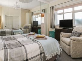A bedroom with a bed and television at Sandy Shore in Bridlington