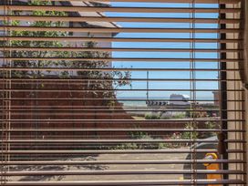 A view through blinds showing a road and ocean at Sandy Shore in Bridlington