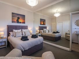 A bedroom with a bed and side tables at Sandy Shore in Bridlington