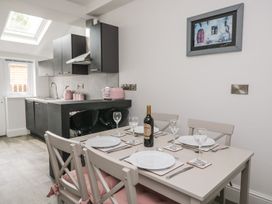 A kitchen with a dining table set for a meal at Billy's Cottage in Maryport