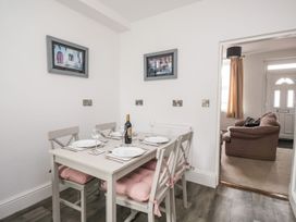 A dining room with a table and chairs at Billy's Cottage in Maryport