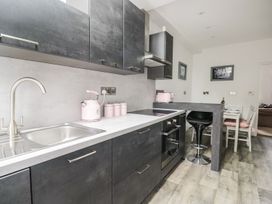 A kitchen with modern cabinets and appliances at Billy's Cottage in Maryport