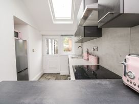 A kitchen with a refrigerator and microwave at Billy's Cottage in Maryport