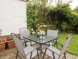 A garden with a table and chairs at Billy's Cottage Maryport