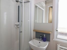 A bathroom with shower and sink at Hafan Y Mor in Aberporth