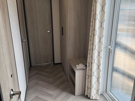 A hallway with a door and a window at Lime Tree Lodge