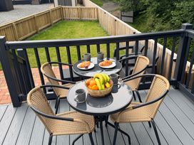 A table with snacks and mugs on a deck at Lime Tree Lodge