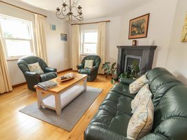 A living room with sofa and armchairs at Ash House in Ballyvaughan