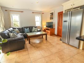 A living room with a sofa and television at Ash House in Ballyvaughan