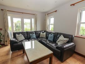 A living room with a sofa and coffee table at Ash House in Ballyvaughan