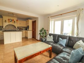 A living room with a sofa and coffee table at Ash House in Ballyvaughan