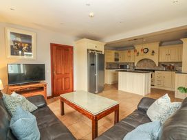 A living room with a sofa and television in Ash House Ballyvaughan