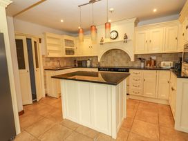 A kitchen with an island and appliances at Ash House in Ballyvaughan