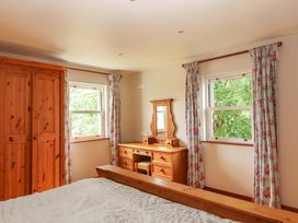 A bedroom with a wardrobe and dressing table at Ash House in Ballyvaughan