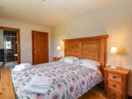 A bedroom with a bed and nightstand at Ash House in Ballyvaughan
