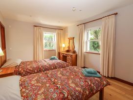 A bedroom with two beds and a dresser at Ash House in Ballyvaughan