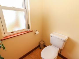 A bathroom with a toilet and window at Ash House in Ballyvaughan