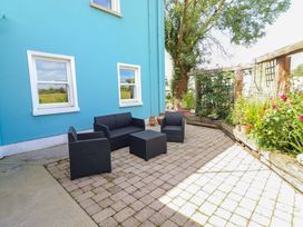 An outdoor seating area with chairs and a table at Ash House in Ballyvaughan