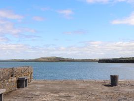 A view of water and sky from a stone pier at Ash House in Ballyvaughan