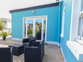 An outdoor patio with seating and a door at Ash House, Ballyvaughan, County Clare