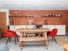 A kitchen with a dining table and chairs at Tigley Meadow Coach House in Totnes