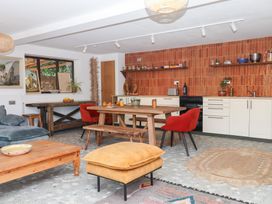 A kitchen with a dining table and chairs at Tigley Meadow Coach House in Totnes