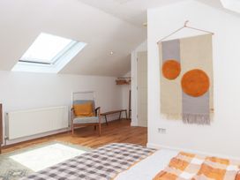 A bedroom with a skylight and furniture at Tigley Meadow Coach House in Totnes