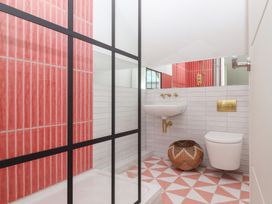 A bathroom with a shower, sink, and toilet at Tigley Meadow Coach House in Totnes