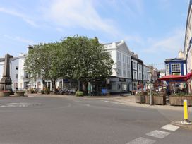 A street view showing buildings and outdoor seating at Tigley Meadow Coach House in Totnes