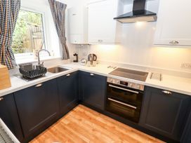 A kitchen with a sink and cooker at School Cottage in Windermere